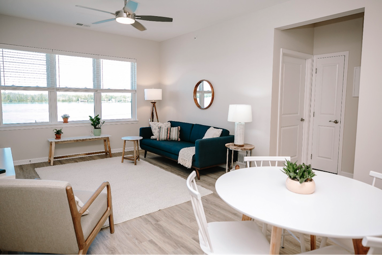 Pictured, above, an open space living room floor plan facing the waterfront at the 600 River Road apartments. 